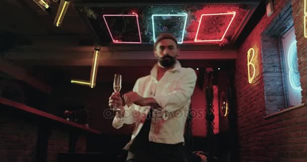 Professional dancer man , with nice choreography dancing in the club and holding one glass of champagne. — Stock Video