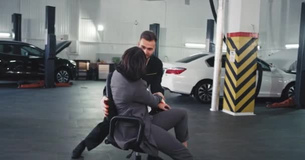 Attractive office worker lady and a garage mechanic auto dancing in front of the camera after they finished their work day — Stockvideo