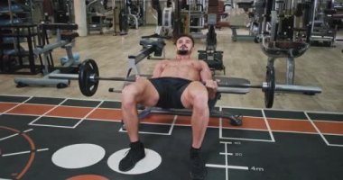 Workout time for a man with a fit body he doing push-ups to get more muscle and have a perfect body in a modern fitness class