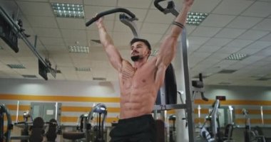 Spor salonunda vücut ve kas egzersizleriyle harika bir atletik. Karın kaslarına ve bacaklarına daha fazla kas yapmak için egzersiz yapıyor.