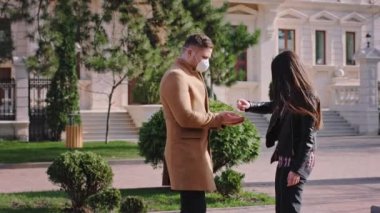 Yeni Covid-19 konsepti. Sokağın ortasında buluşuyorlar. Sarılmadan önce maske takıyorlar.