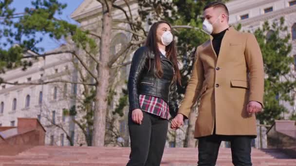 A couple looking straight to the camera in the middle of empty street they wearing protective masks while is the quarantine of the Coronavirus 2019. Shot on ARRI Alexa Mini — Stock Video