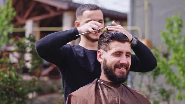 Felice ragazzo hanno un tempo di taglio di capelli a casa in giardino che discute con il barbiere e sorridente grande insieme — Video Stock