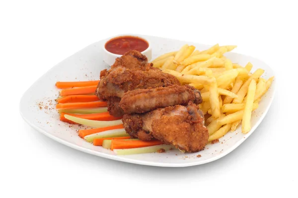 Fried chicken and fries, vegetable sticks and sauce on white background