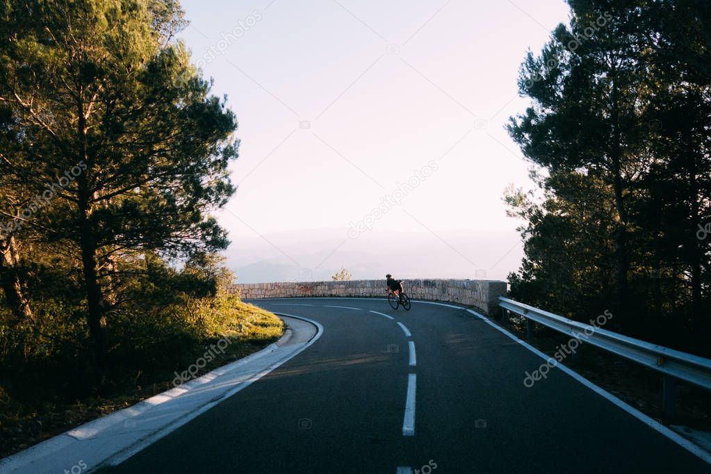 female cyclist riding on road 