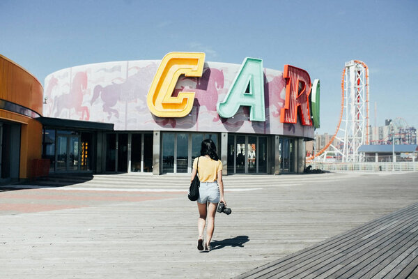 female student with camera walks
