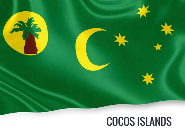 Flagga av australiska staten Kokosöarna viftande på en isolerad vit bakgrund. Statliga namn ingår under flaggan. 3D-rendering. — Stockfoto