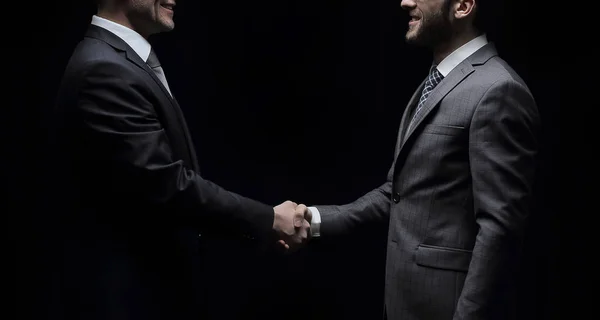 Two cheerful businessman shaking hands and looking at each other — Stock Photo, Image