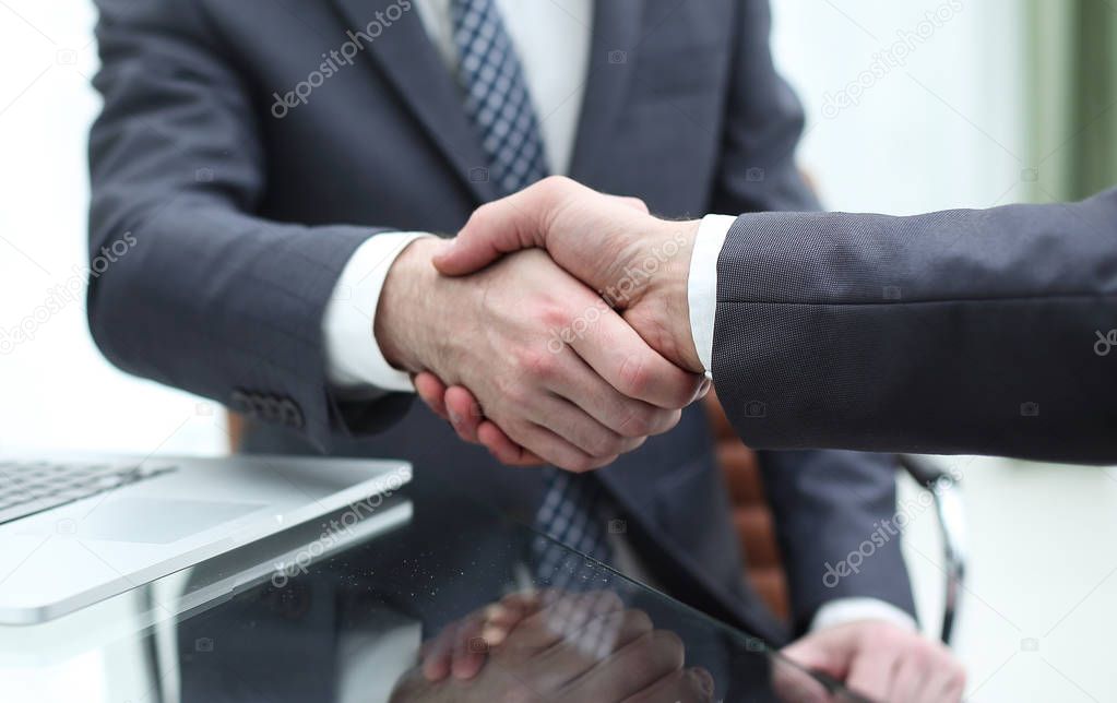 Business people shaking hands after good deal