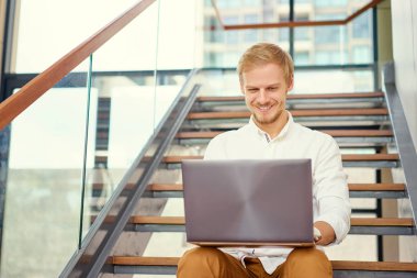 dizüstü bilgisayar üzerinde çalışan genç adam 