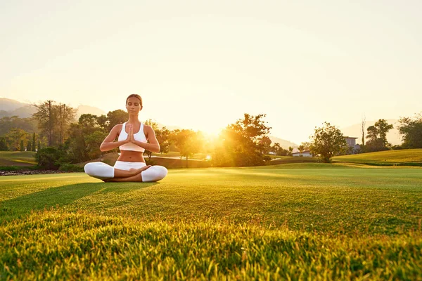 Young woman in lotus pose — Stock Photo, Image