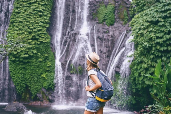 年轻女人享受着瀑布的景色 — 图库照片