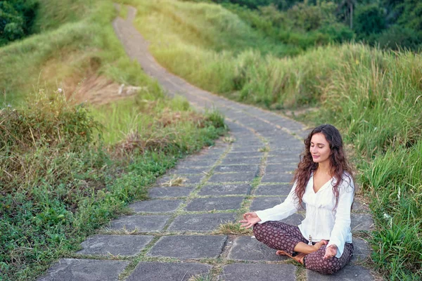 Young woman in lotus pose — Stock Photo, Image