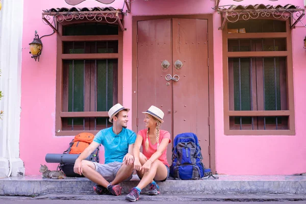 Couple of backpackers on asian street