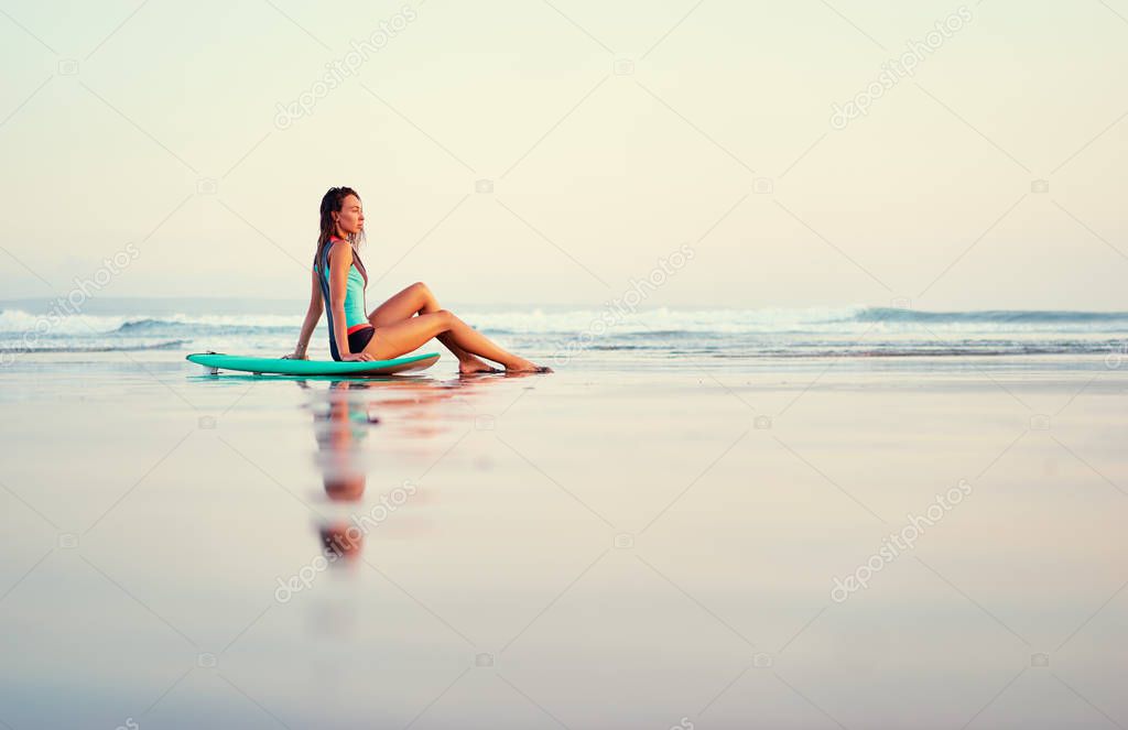 Woman sitting on sand 