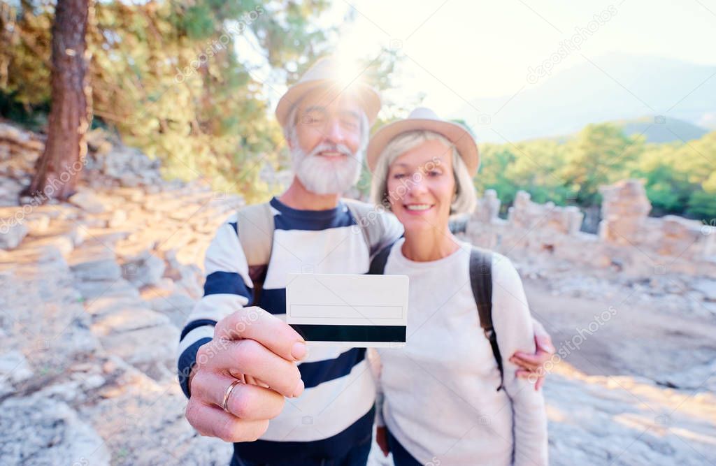 Senior couple holding credit 