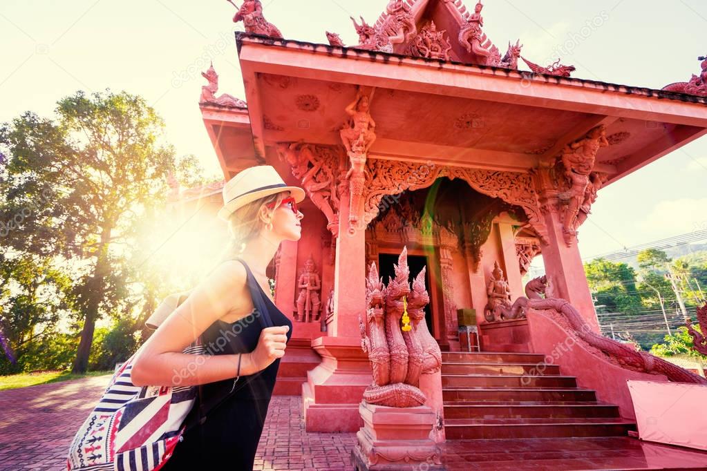 woman walking near buddhist temple