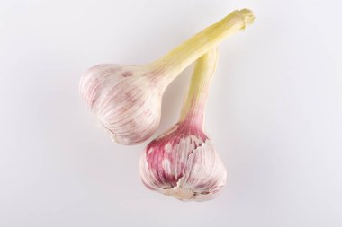 Beyaz arka planda taze sarımsak başları.