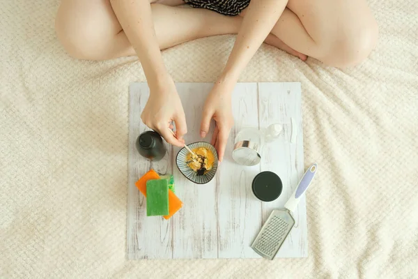 DIY cosmetics. hands in the frame create a cream of different ingredients.