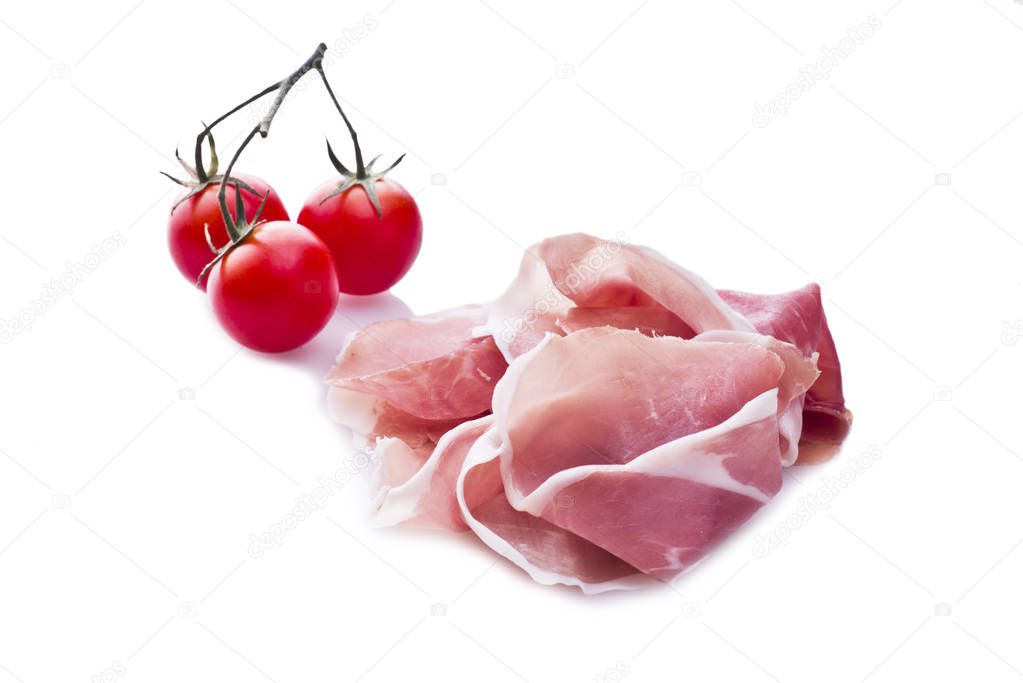 Raw ham leg sliced  with three tomatoes
