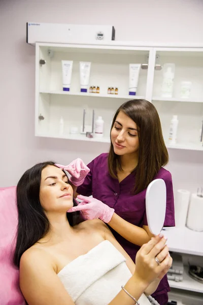 attractive female beautician doctor doing beauty injection for the patient