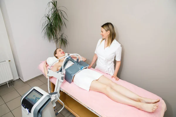 young woman doctor making ultrasound procedure for the abdomen of the patient