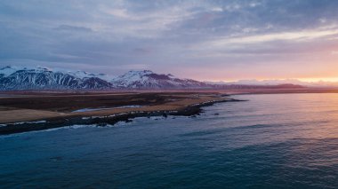 beautiful sunset on landscape Iceland beach in Norwegian sea