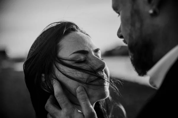 tender and touching portrait of couple in love on sunset of black sand Iceland beach background