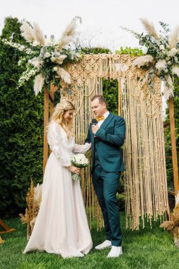 Güzel bir boho tarzı düğün töreni. Güzel elbiseli gelin ve klasik takım elbiseli damat.