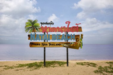 PHANGNGA, THAILAND - MARCH 16, 2017:  Signboard with the name of the Natai Beach, Thailand clipart