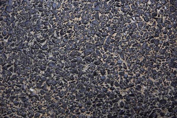 Pavimento de fondo abstracto formado por pequeñas piedras incrustadas en cemento — Foto de Stock