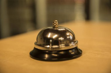 Vintage hotel reception service desk bell. Old retro style filtered photo clipart