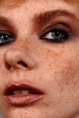 Closeup makro kadın yüzü portresi. İnsan kadın yarım-gün güzellik makyaj ile yüz. Mükemmel cilt ve çiller ile kız.