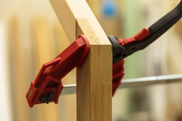 Detail of a furniture maker holding an example of his intricate Japanese joinery