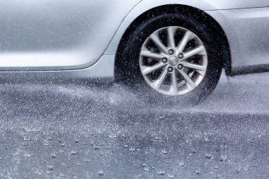 Hareket eden araba yağmuru Tekerleklerden fışkıran su birikintisi