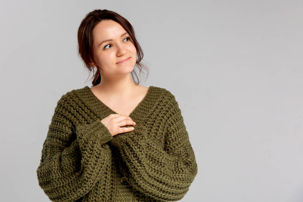 Smiling attractive happy young girl laughing carefree having fun grinning joyfully bending forward cute silly, posing silly. Tender european woman chuckling flirty looking, standing gray background