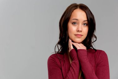 Gülümseyen, akıllı giyimli, zarif bir gece elbisesi içinde etkileyici makyajlı güzel bir kadının portresi.