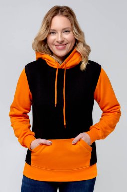 Woman in black and orange hoodie, mockup for logo or branding design clipart
