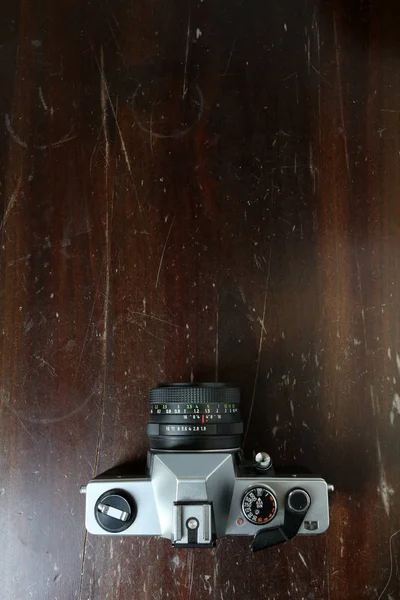 Vintage Photo Camera on a brown wooden surface — Stock Photo, Image