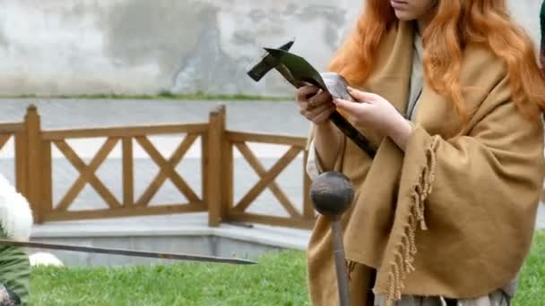 Dacian workers makes a demonstration of making a spear and instruments of battle — Stock Video
