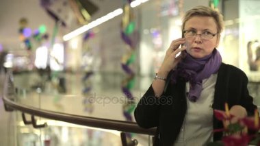 Kadın telefonda konuşurken alışveriş merkezinde