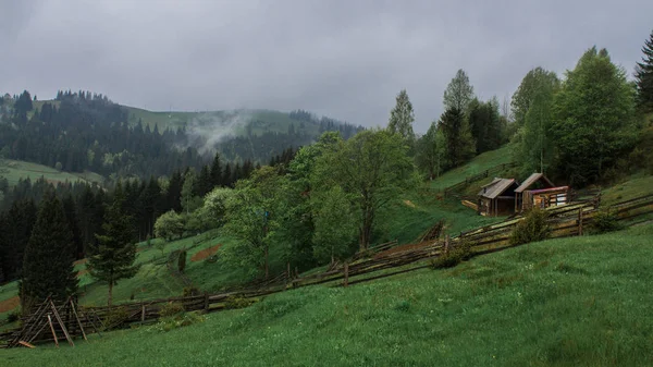 Morning sun rays in the fog mountains house — Stock Photo, Image