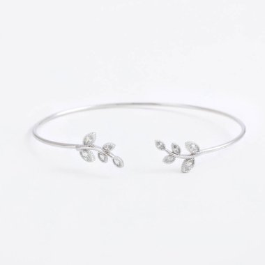 Yaprakları ve taşlar ve kristaller gri bir arka plan üzerinde lüks ince güzel gümüş bileklik