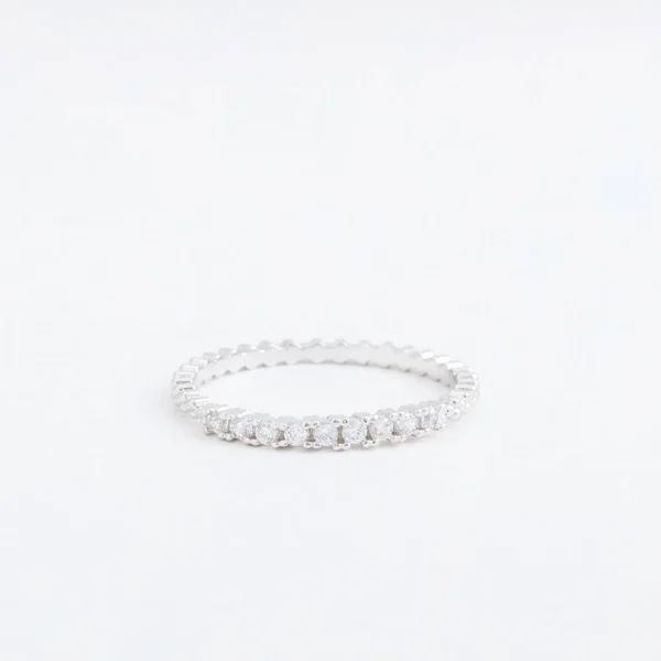 Luxurious silver jewelry ring with transparent crystals, rhinestones drops, on a grey background — Stock Photo, Image