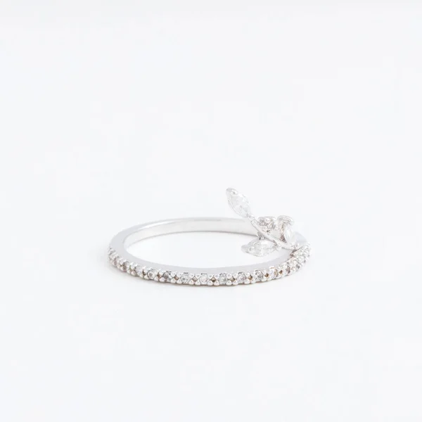 Luxurious silver jewelry ring with transparent crystals, rhinestones drops, on a grey background — Stock Photo, Image