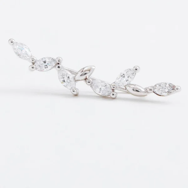 Luxus gyönyörű fény fényes ezüst mandzsetta fülbevaló kristályokkal, csepp egy szürke háttér — Stock Fotó