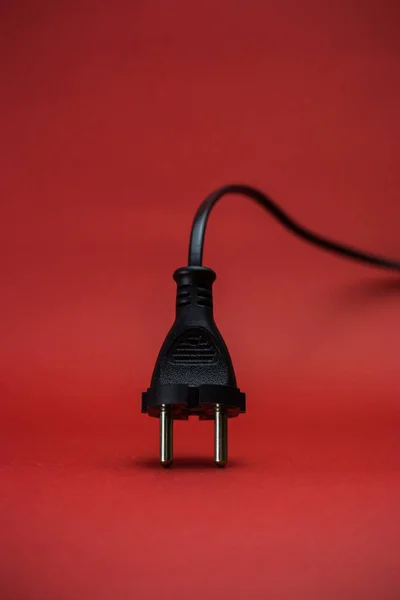Electric plug on a red background