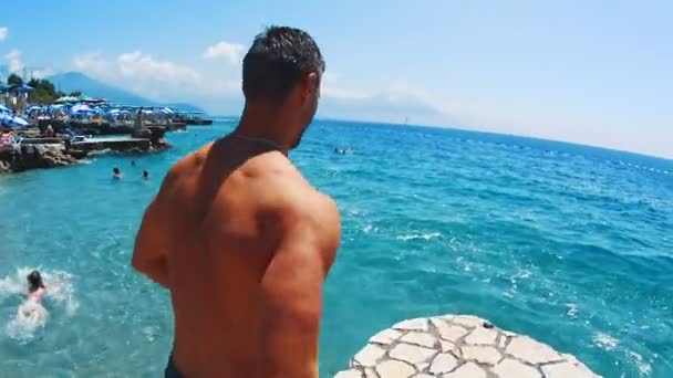 Athletic Young Man Jumping in the adriatic sea — Stock Video