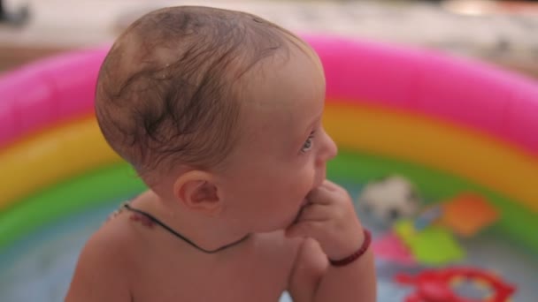 Baby-boy baadt in een pool — Stockvideo