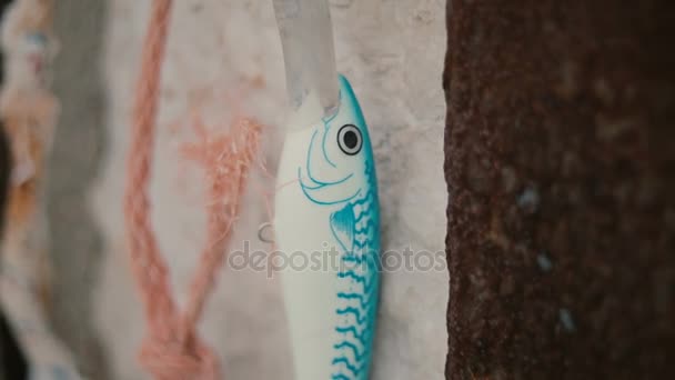 Fishing lure - wobbler against the background of the sea. Bait, fish, bait, bait for fish. — Stock Video